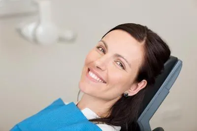 woman smiling in the dental chair during her visit to Smiles Dental Center