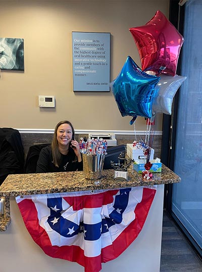 front office coordinator at Smiles Dental Center on the phone with a patient