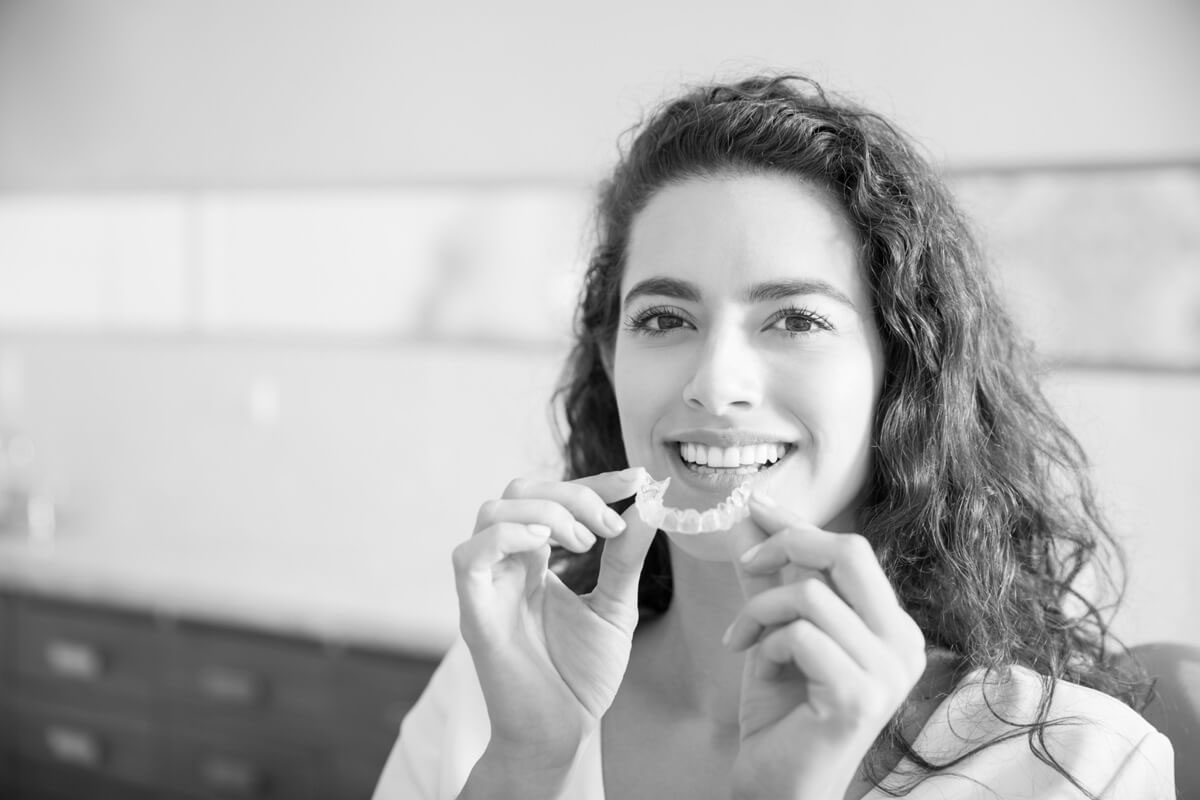 woman smiling with her new clear aligners