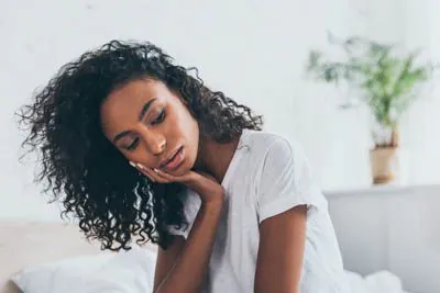 Woman holding her jaw in pain